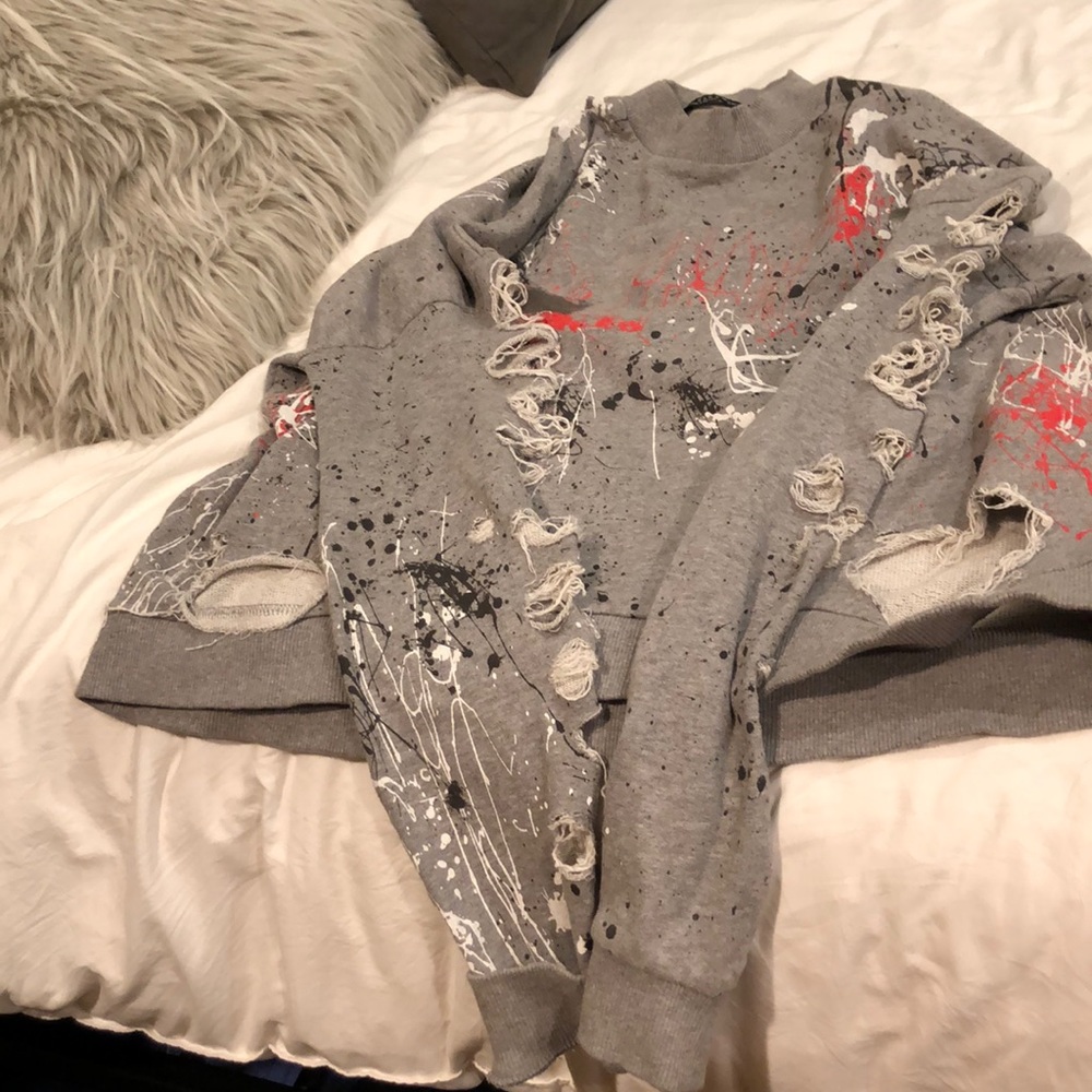 ripped up, splattered sweatshirt